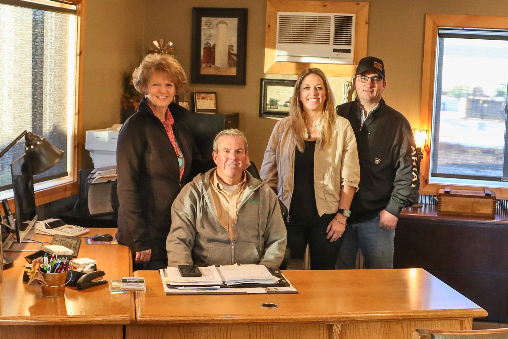 SHOWN LEFT TO RIGHT: Kimberly Ahrenstorff, Jerry Caffee, Hilary and Todd Grohs at the implement dealership offices.