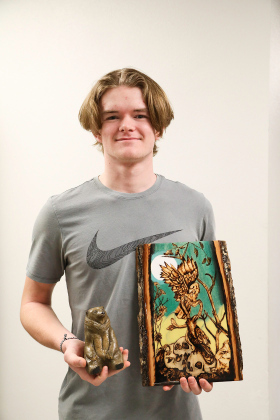  Wynand Bothma with 3-D piece “Sitting Bear,” second place and “Grim Reality,” 3rd place in the Mixed Media division.