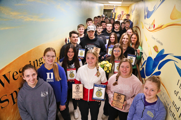 Gathered with their fellow Wessington Springs FFA Chapter members, state-bound students display recent awards they’ve earned at area Career Development Events (CDEs). They are shown in the celebrated mural-lined FFA hallway leading to the vo-ag shop at Wessington Springs High School (WSHS). The mural, painted by WSHS alumna and former FFA member Kenzee Schafer, depicts the rich history of the local chapter’s FFA program. 