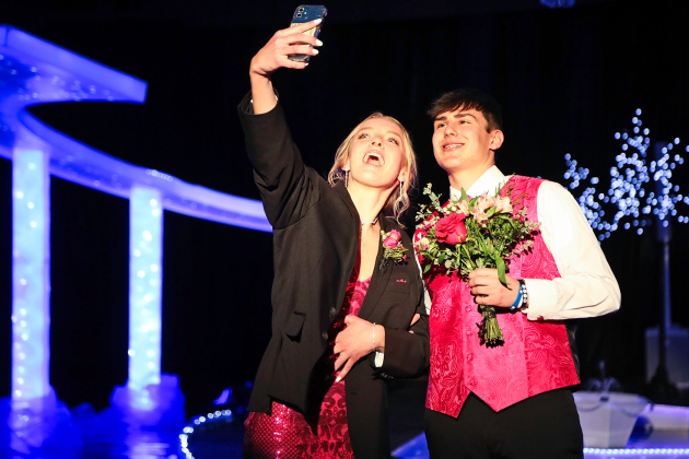 Abby Kolousek, escorted by Blake Miller, snaps a selfie of the prom-goers. 
