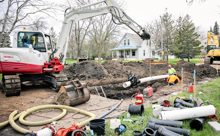 Underground work began Tuesday as a Menning Excavating crew, shown above, worked on installing new water mains at the corner of College Avenue and 2nd Street. KRISTI HINE / TRUE DAKOTAN
